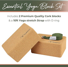Two natural cork yoga blocks with rounded edges and a green cotton yoga stretch strap with D ring and metal buckle, displayed on a white background.