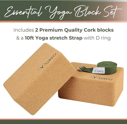 Two natural cork yoga blocks with rounded edges and a green cotton yoga stretch strap with D ring and metal buckle, displayed on a white background.