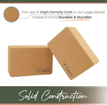 Two natural cork yoga blocks with textured surface and rounded edges, one laid flat and one angled, with "GAYO" branding visible. Close-up circular inset shows high-density cork material detail.