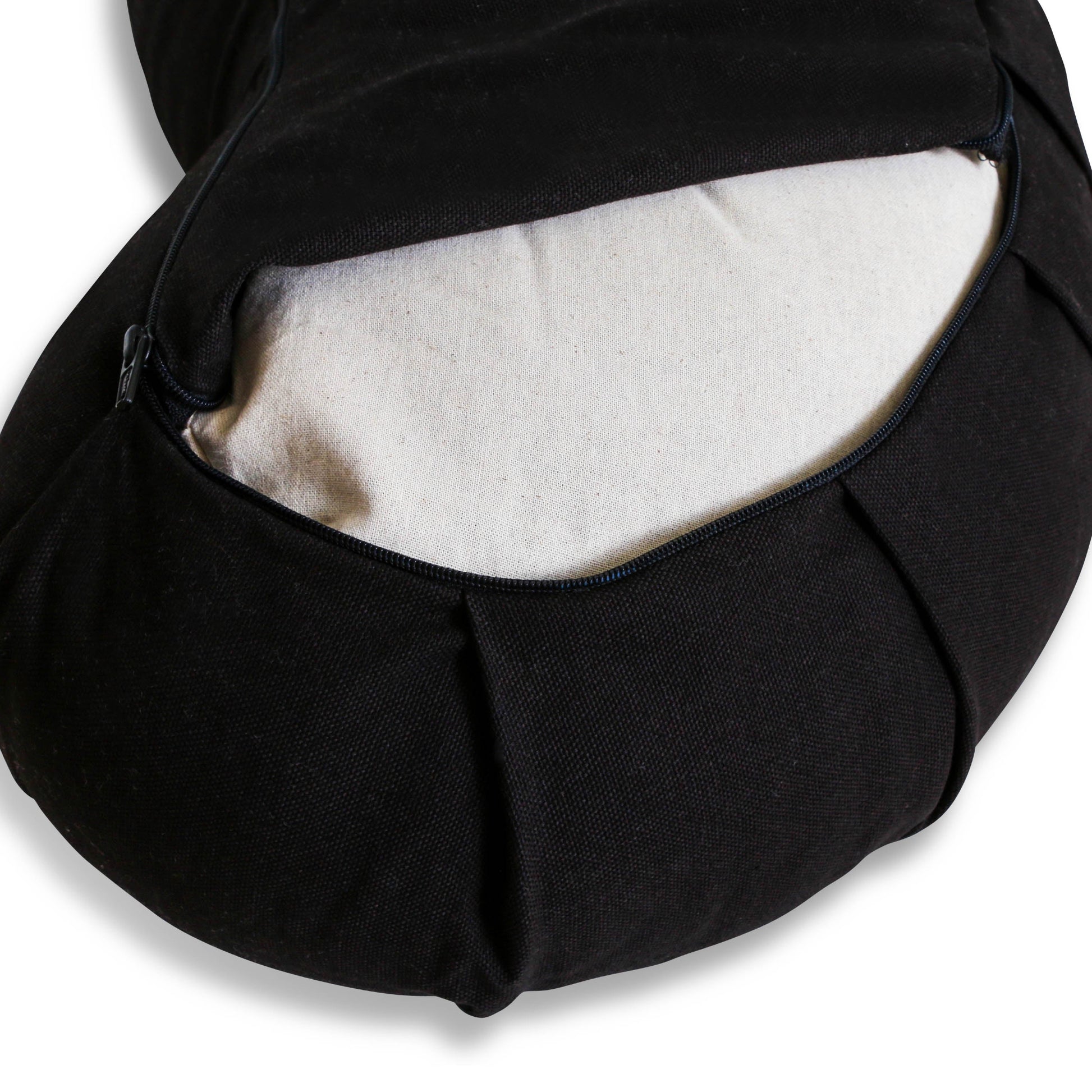 Close-up of black fabric bag with zipper open, beige interior.
