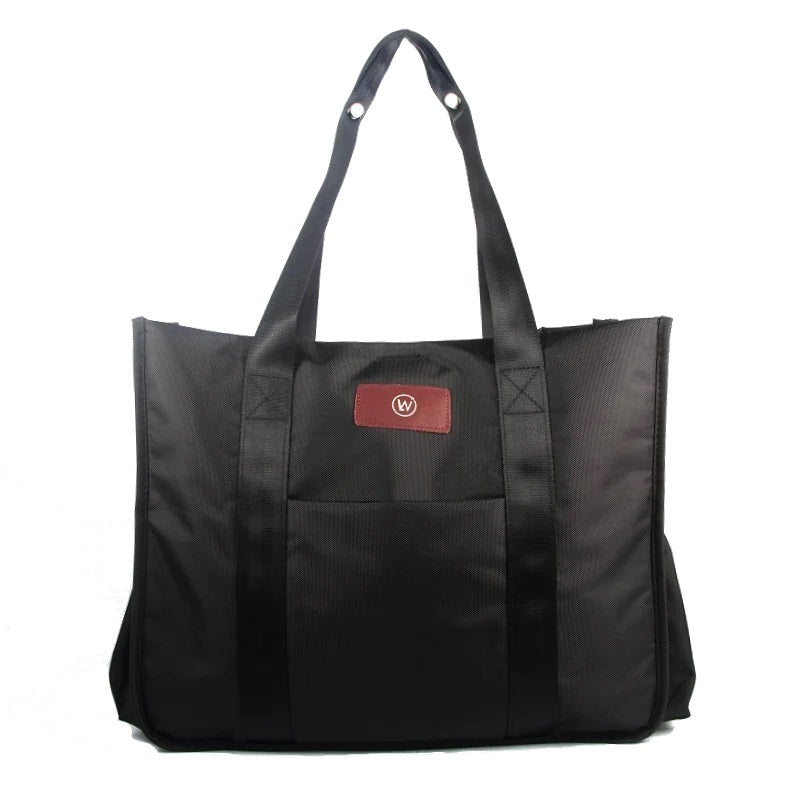 Black tote bag with two handles and a red logo patch.