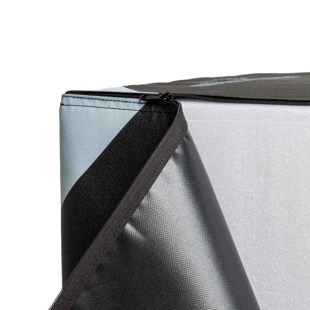 Close-up of zipper on corner of a metallic fabric box.