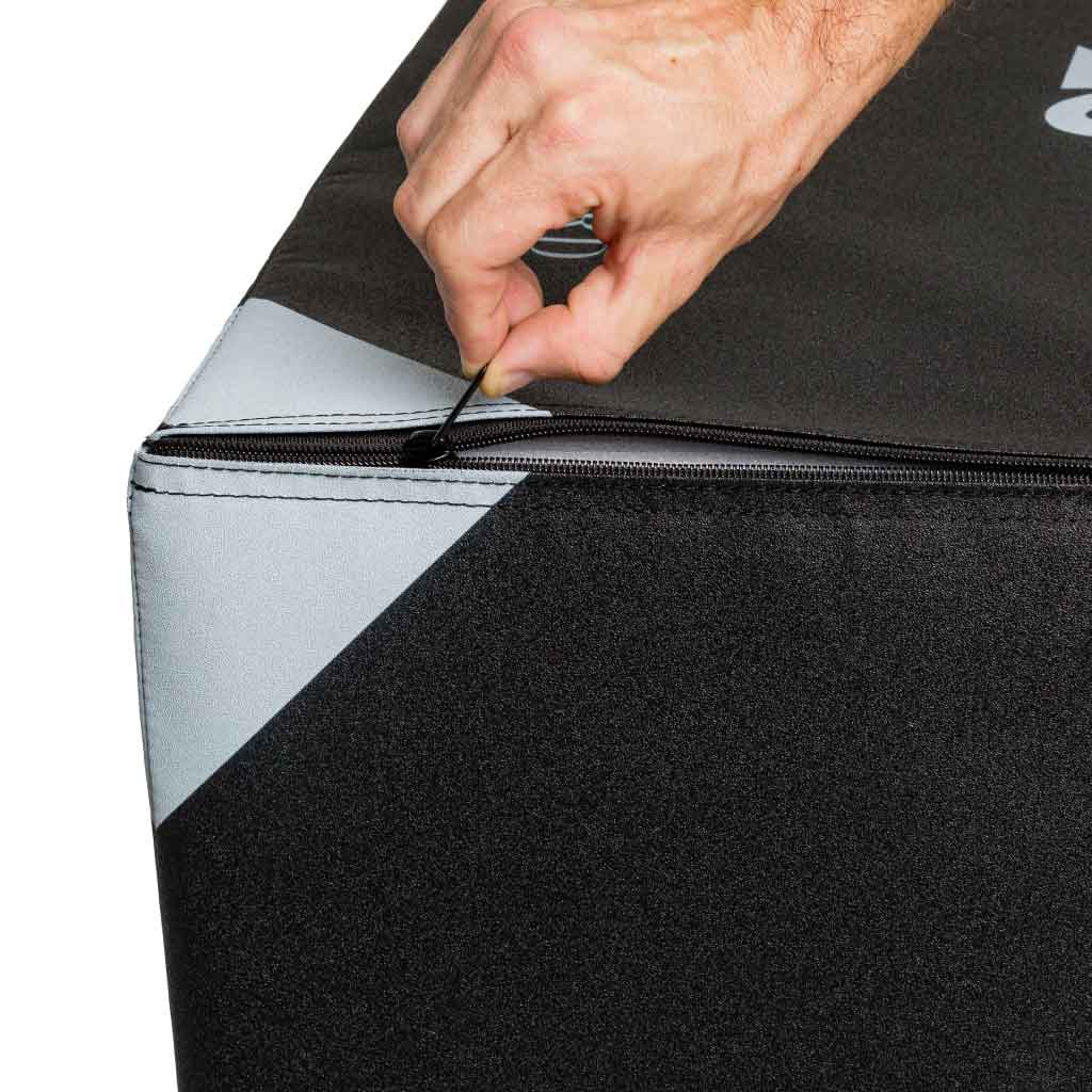 Close-up of hand unzipping a jump box cover (black/gray panels).