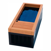 Modern soaking tub with a wooden frame and a dark base, featuring a sleek design and clear water reflecting the sky.