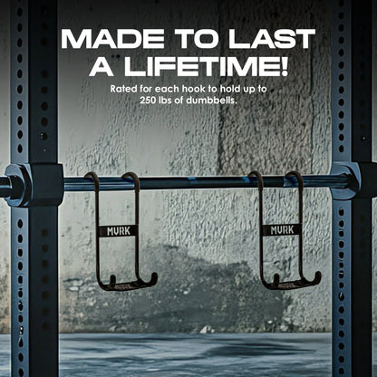 Two hooks labeled “MVRK” on a squat rack in a gym setting.