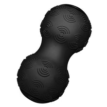 Black massage ball with a unique textured surface, shaped like a peanut, designed for muscle relief and trigger point therapy.