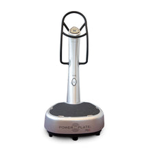 A Power Plate my5, a vibration exercise machine with a sleek silver design, featuring a textured platform and a control panel on the handle.