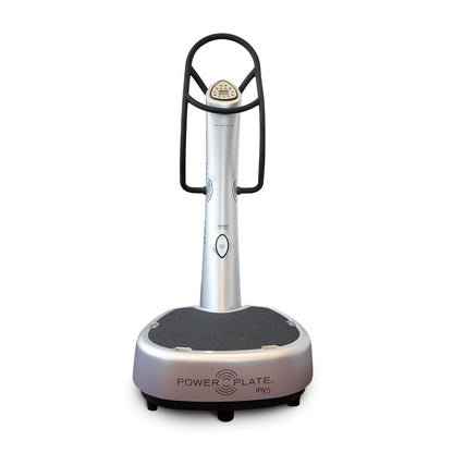 A Power Plate my5, a vibration exercise machine with a sleek silver design, featuring a textured platform and a control panel on the handle.