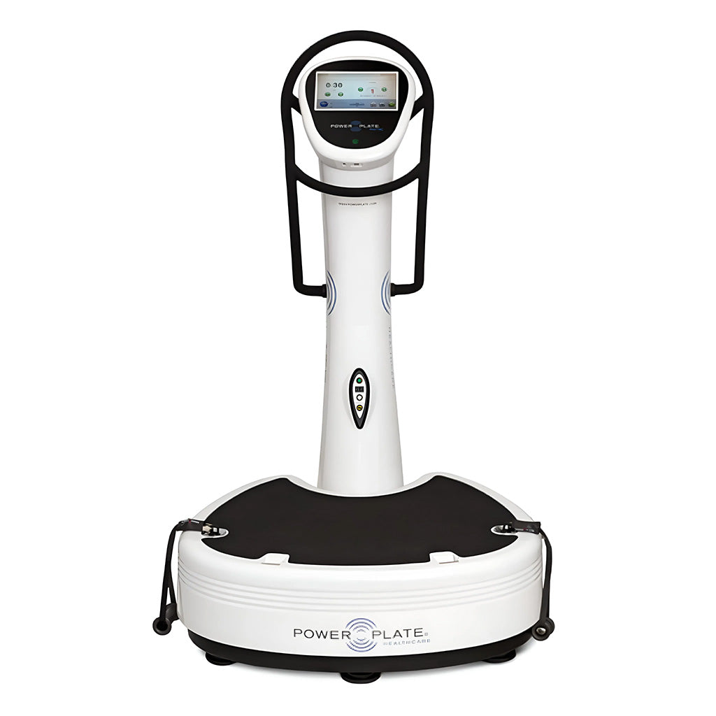 A Power Plate vibration training machine featuring a black platform and a digital control panel on a white vertical post with handles on either side.