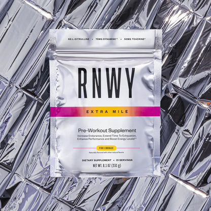 White and silver foil pouch of RNWY pre-workout supplement in pink lemonade flavor, labeled "Extra Mile," containing 6g L-citrulline, 75mg Dynamine, and 50mg Teacrine, displayed on a reflective silver background.