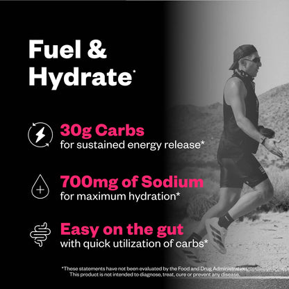 Man trail running on a desert path wearing black athletic tank and shorts, with product feature callouts listing 30g carbs, 700mg sodium, and gut-friendly formulation.