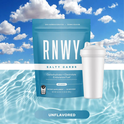 Turquoise RNWY Salty Carbs endurance fuel pouch with 30g carbohydrates and 700mg sodium next to a white shaker bottle, set against a blue sky and water background.
