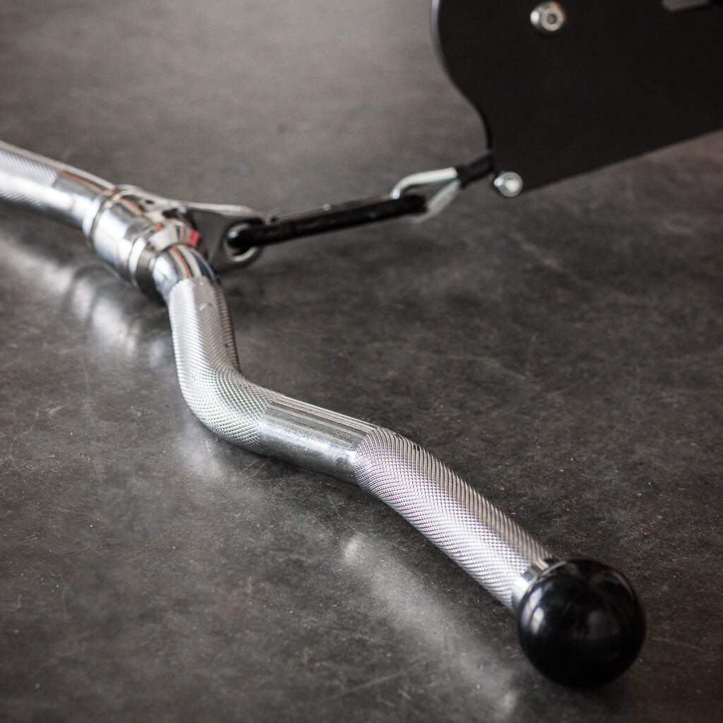 Textured metal curl bar with black ball end on a gym cable attachment.