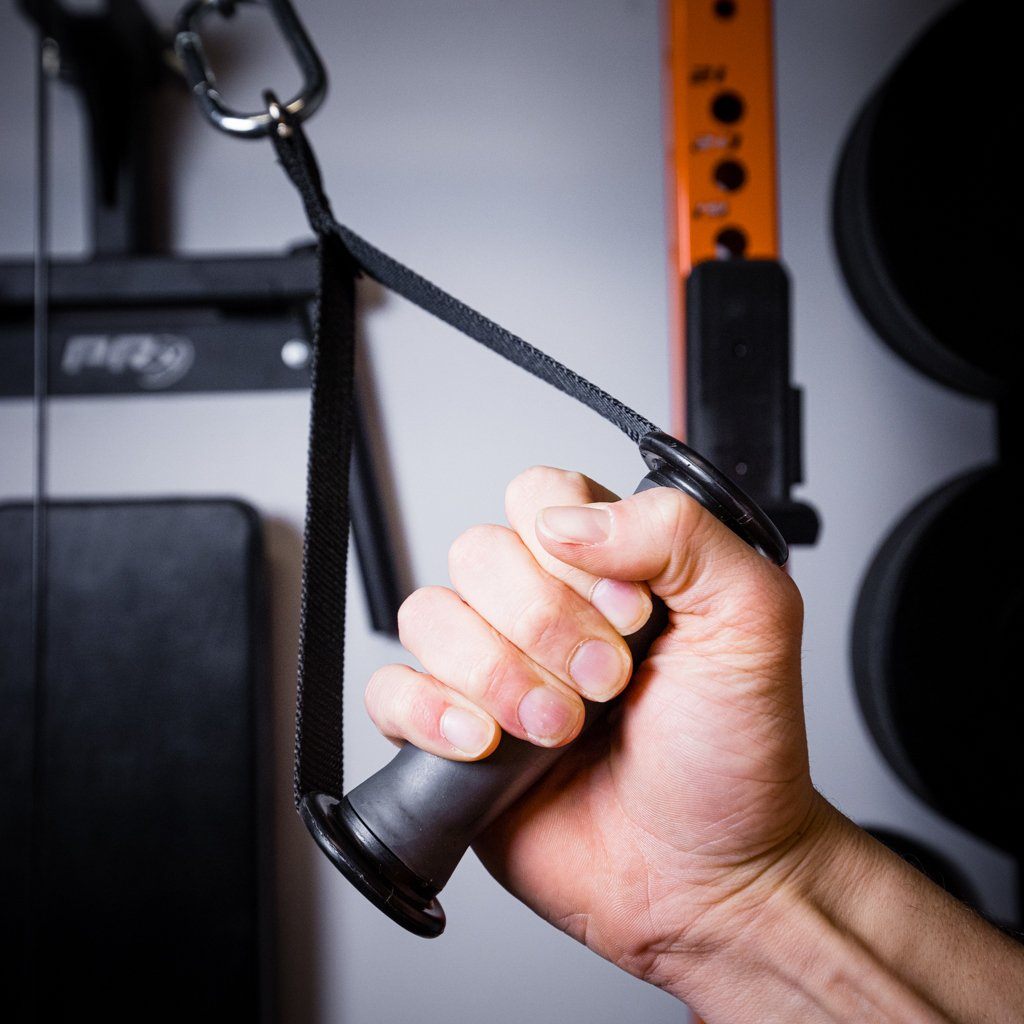 Close-up of hand gripping a PRx single grip pulley handle with strap.