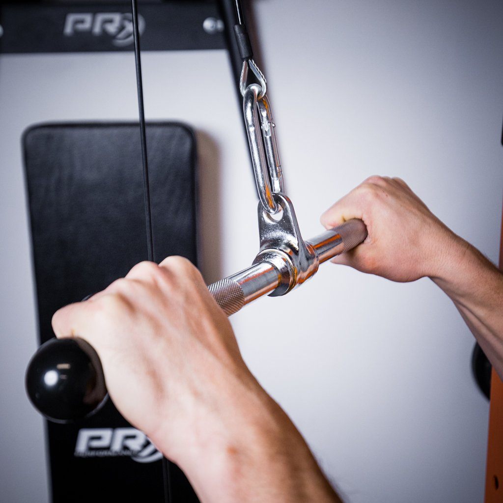 Hands gripping a chrome straight bar on a pulley system with carabiner.