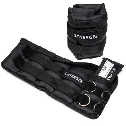 Black adjustable wrist and ankle weights by Synergee with neoprene padding, velcro straps, and metal D-rings for attachment. Set includes wrist cuffs and ankle weights with weight compartments.