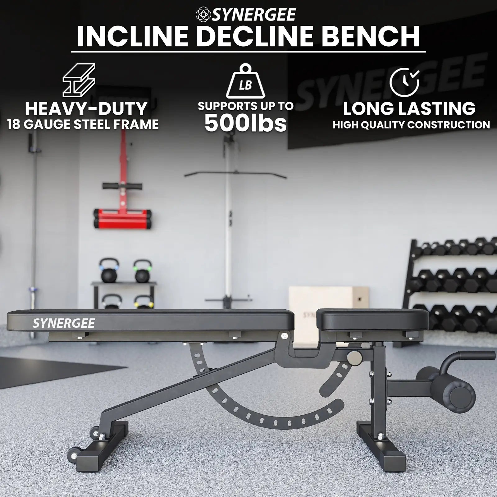 Synergee adjustable incline decline bench with black padded seat and backrest, angle adjustment mechanism visible underneath, positioned in a gym setting with kettlebells and dumbbells in the background.