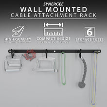 Black steel wall-mounted cable attachment rack with six storage posts holding various exercise cables and accessories including resistance bands and rope attachments.
