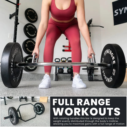 Woman performing a deadlift with a black hex trap bar loaded with Synergee weight plates in a gym setting.