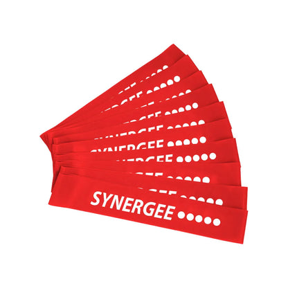 Set of red fabric resistance bands fanned out, displaying white Synergee branding and circular resistance level indicators on each band.