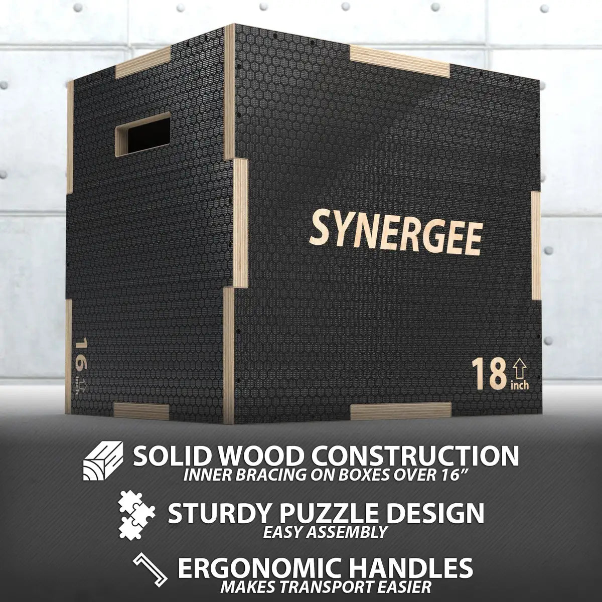 Black textured plyo box with light wood frame edges and handles, labeled "SYNERGEE" and marked "18 inch" height, shown against white brick background.
