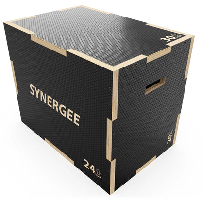 Black and wood plyo box with textured rubber top surface and side handles, marked "SYNERGEE" and "24 inch" height measurement.
