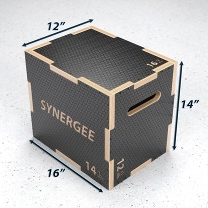Wooden plyo box with black textured rubber top and sides, natural wood frame, and bronze handles. Dimensions marked as 12" x 16" x 14" with "SYNERGEE" branding visible.