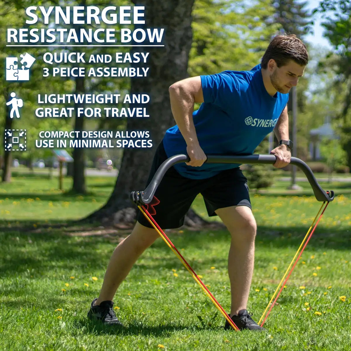 Man performing a rowing motion with a black curved resistance bow connected to red and yellow resistance bands in an outdoor park setting.