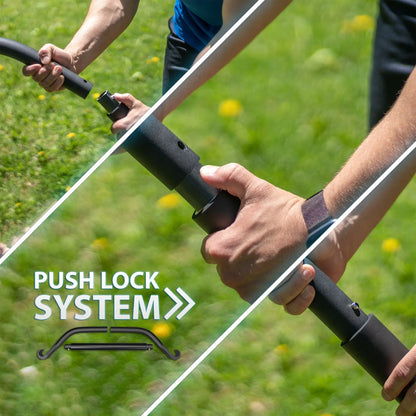 Man's hands gripping a resistance bow with black foam handles and a push lock system, demonstrated outdoors on grass.