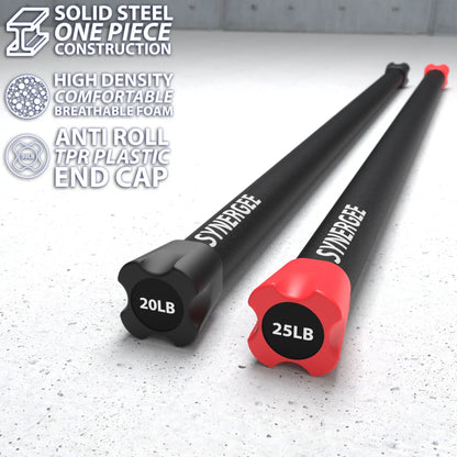 Two weighted bars with black foam handles and plastic end caps on a speckled concrete floor; left bar marked 20LB with black cap, right bar marked 25LB with red cap.
