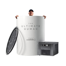 A person smiling and peeking out from the top of a large, white cylindrical container labeled THE ULTIMATE HUMAN, with a smaller device labeled powered by coldlife next to it.